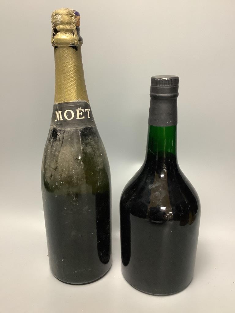 A bottle of Moet & Chandon, A bottle of Chivas Regal and two other bottles